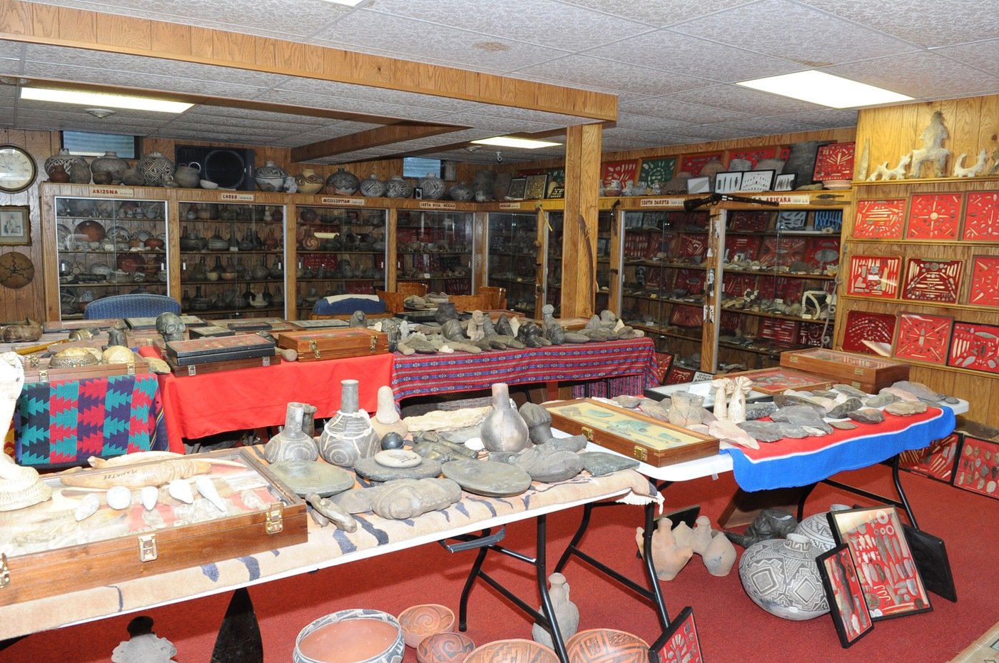 room with wooden shelves and tables covered with artifacts