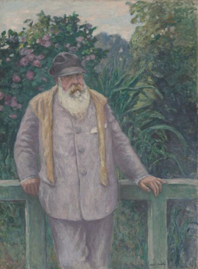 man with a white beard wearing a black hat standing in front of a wooden railing